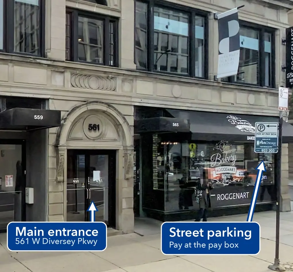 Street view of 561 W Diversey Pkwy: the arched doorway marked 561 is the main entrance, with a pay-box street parking sign at the curb